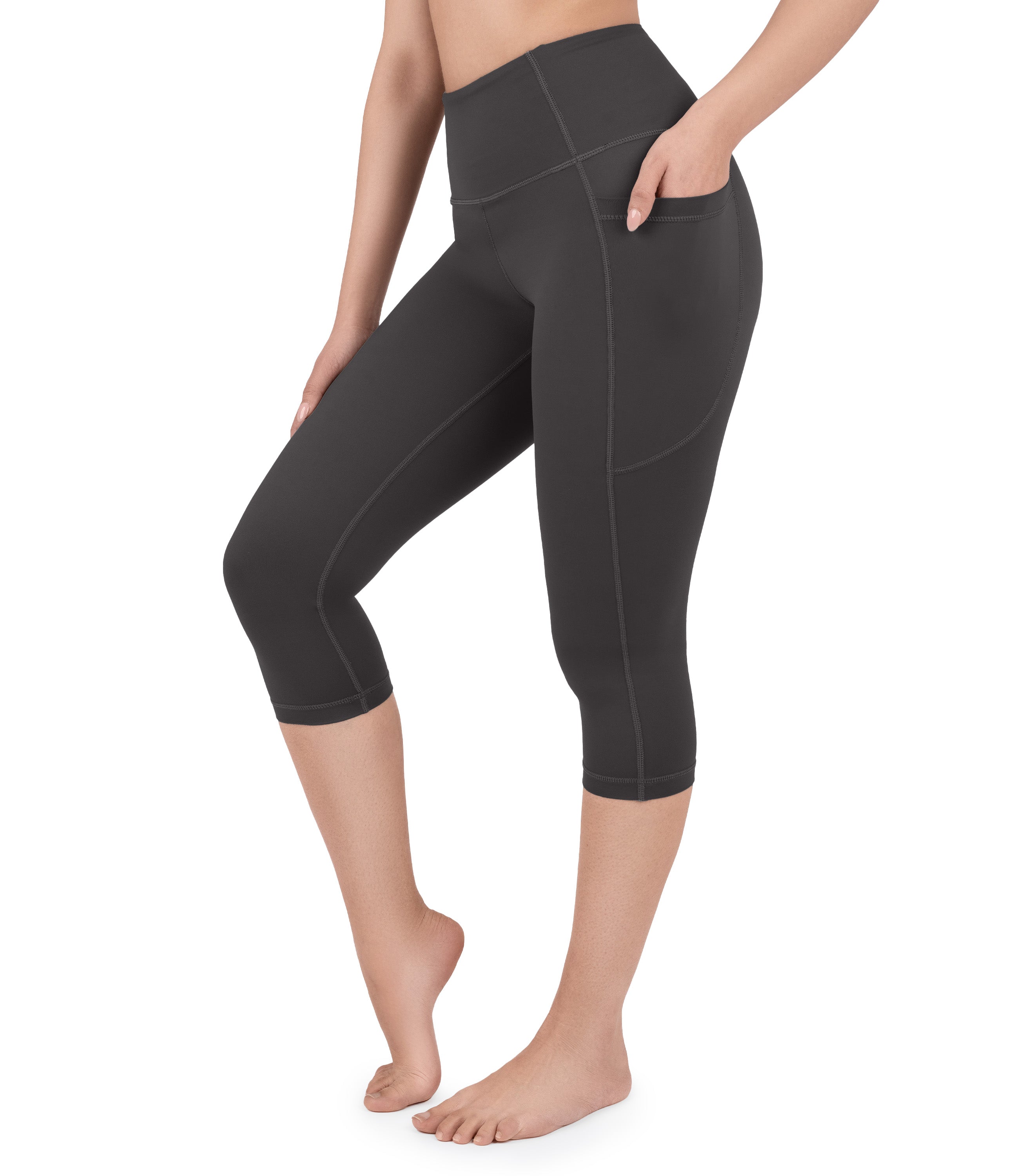 Front view of woman wearing NirLUX capri leggings with pockets in grey rabbit