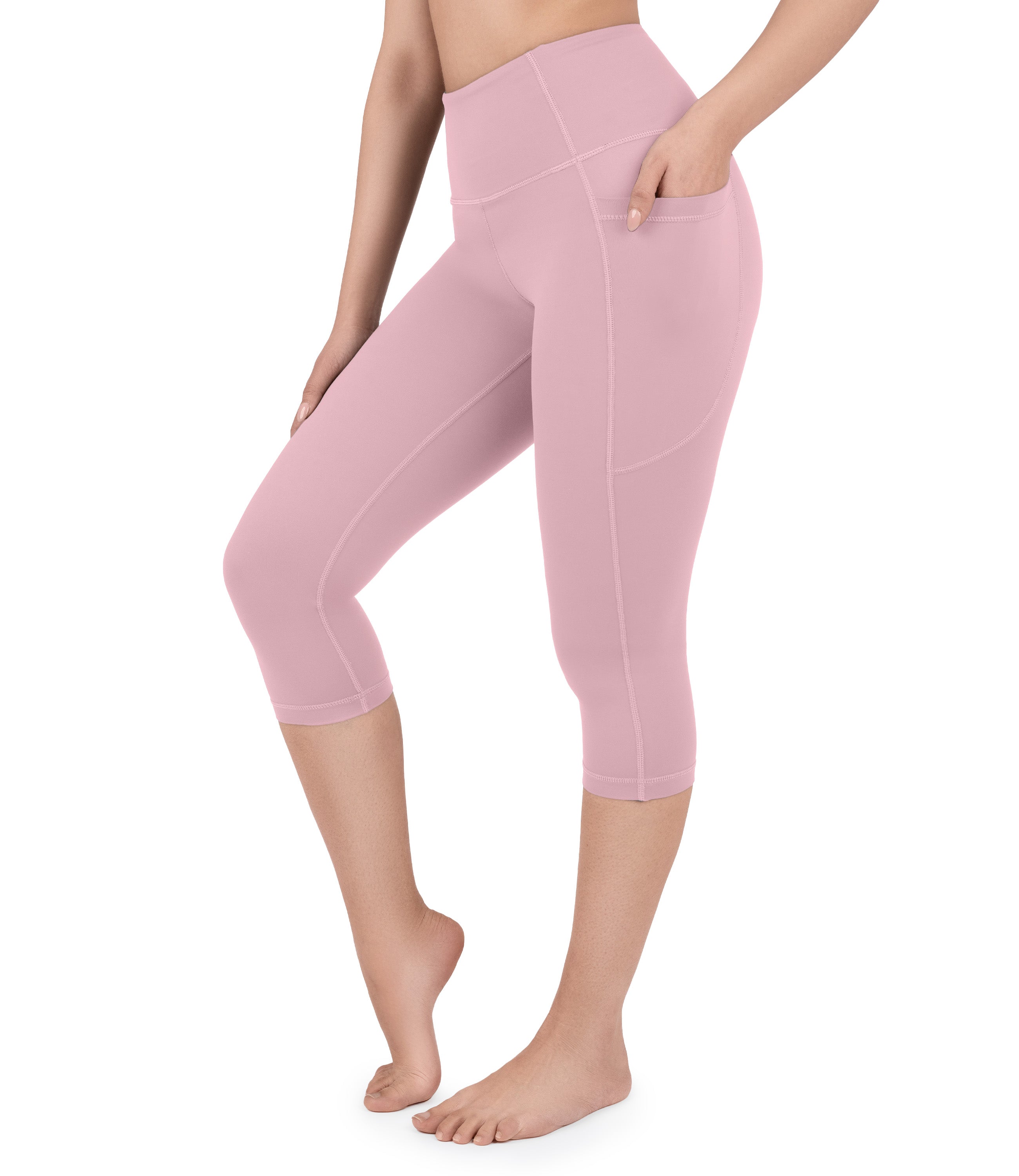 Front view of woman wearing NirLUX capri leggings with pockets in lilas