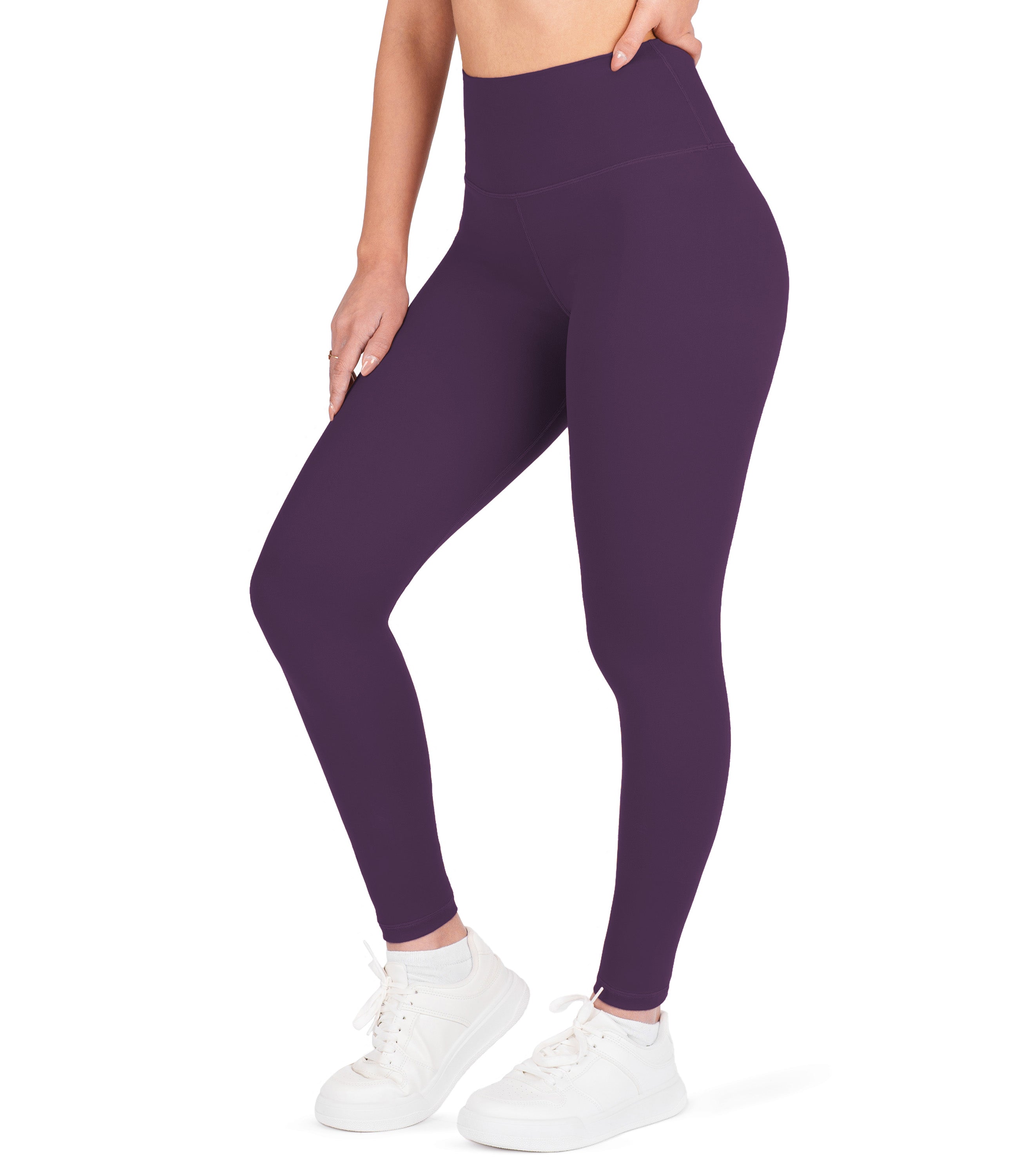 Front view of woman wearing NirLUX high waist ankle leggings in plum purple