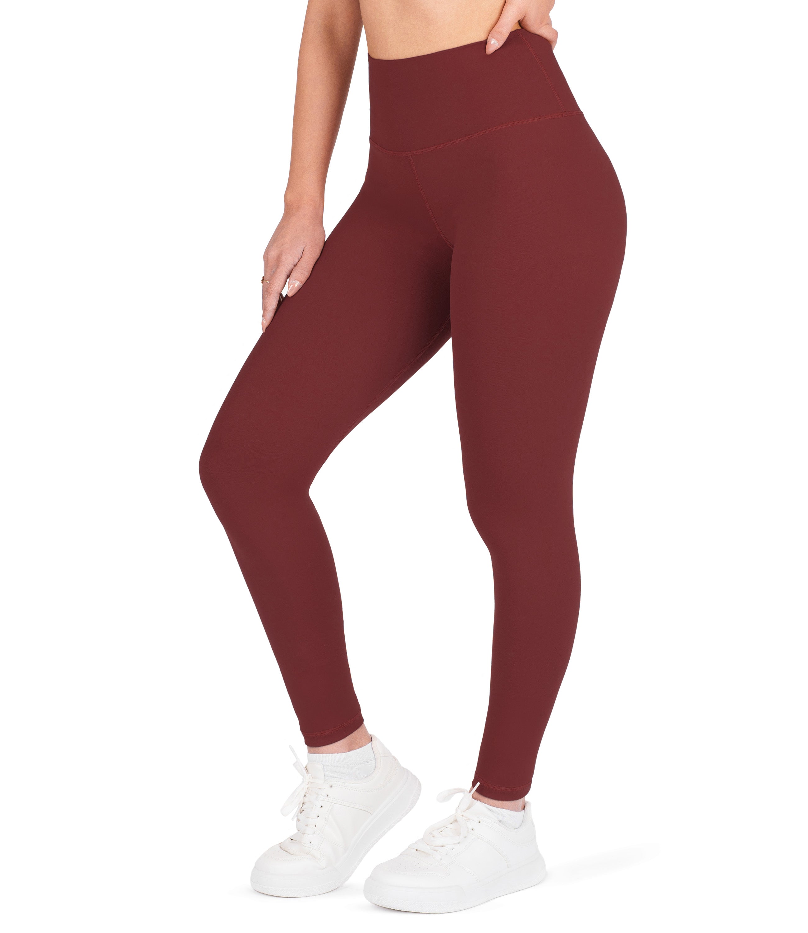 Front view of woman wearing NirLUX high waist ankle leggings in rio red