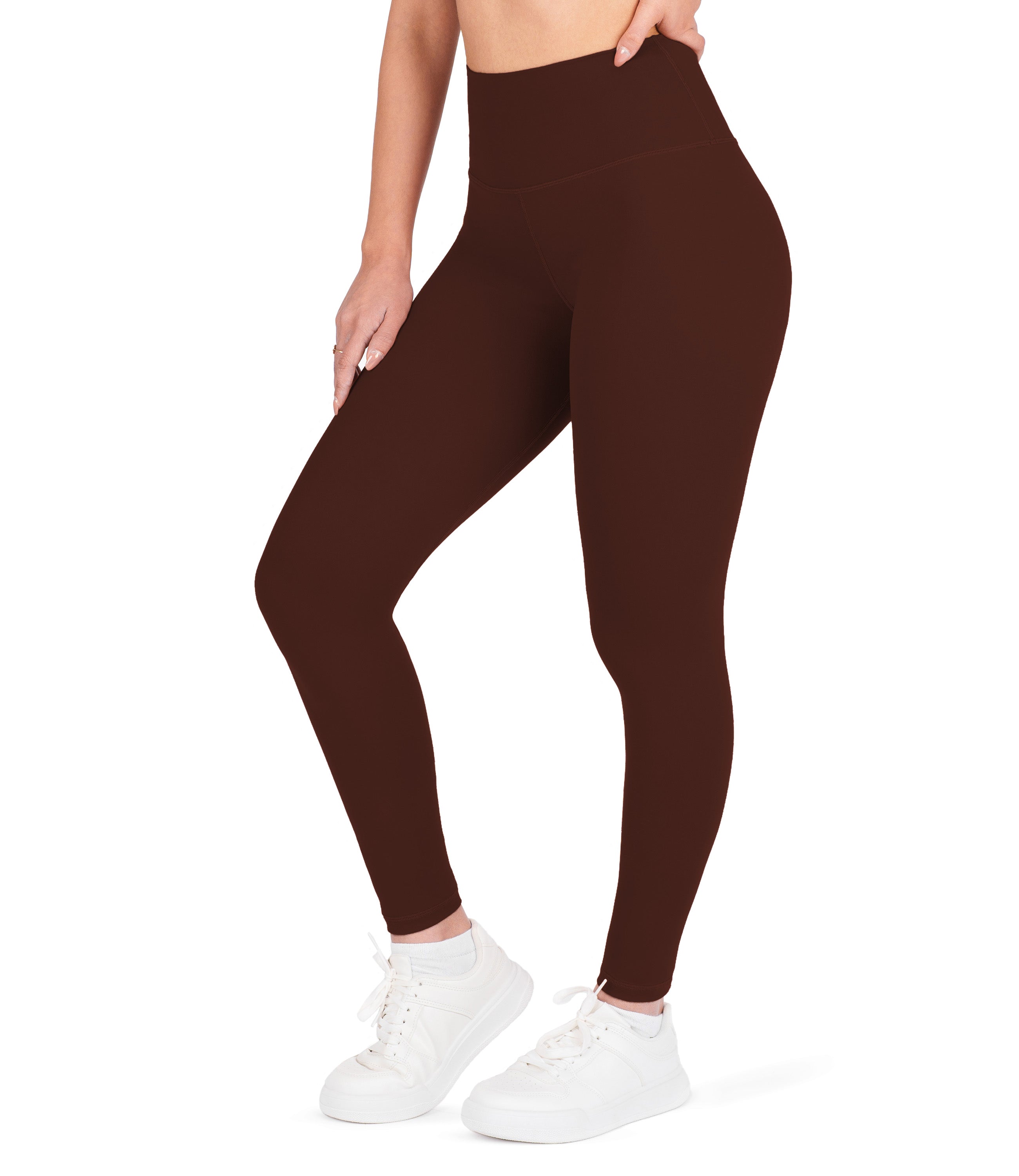 Front view of woman wearing NirLUX high waist ankle leggings in rum raisin