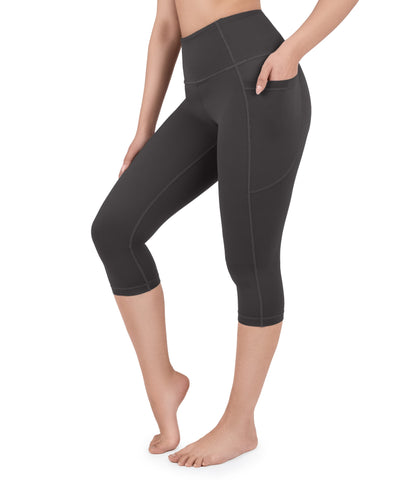 Front view of woman wearing NirLUX capri leggings with pockets in grey rabbit
