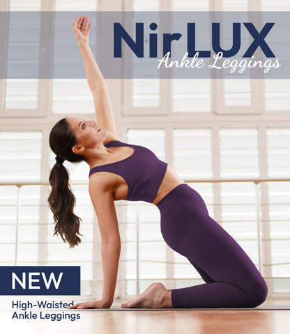 Woman wearing NirLUX yoga leggings in plum purple, full-body view